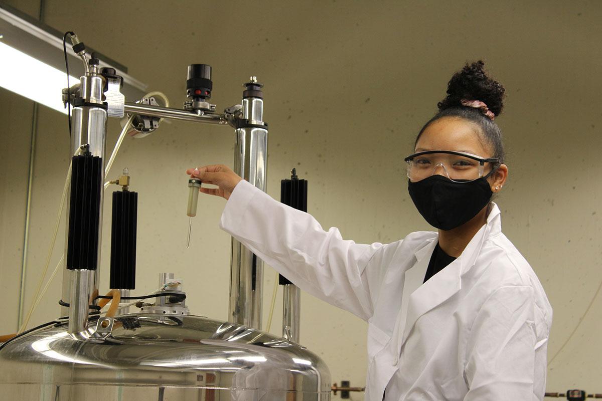 student operates lab equipment